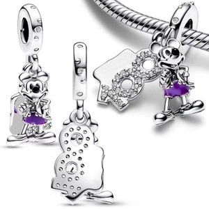 May include: Three silver charm beads featuring Mickey Mouse. One bead shows Mickey Mouse in a purple outfit, another bead shows Mickey Mouse with the number 90, and the third bead shows Mickey Mouse with the number 90 with a sparkly design.