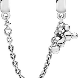 May include: A silver charm bracelet with a Mickey Mouse charm and a chain extender. The charm is a silver Mickey Mouse head with three round ears.
