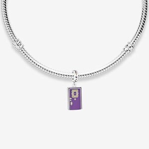 May include: A silver charm bracelet with a purple charm featuring a door with a gold frame and the words "Central Perk" in yellow letters.