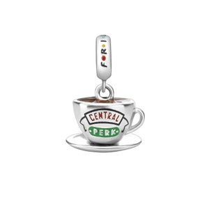 May include: Silver charm featuring a coffee cup and saucer with the words "Central Perk" in green and red lettering.