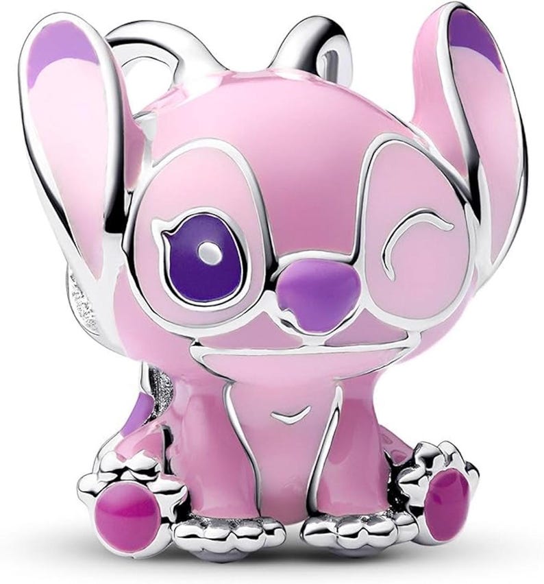 May include: A pink and purple charm featuring a cartoon character with large ears and a winking expression. The charm has a silver-colored outline and accents, with a glossy finish. The character's eyes, nose, and feet are a darker shade of purple.