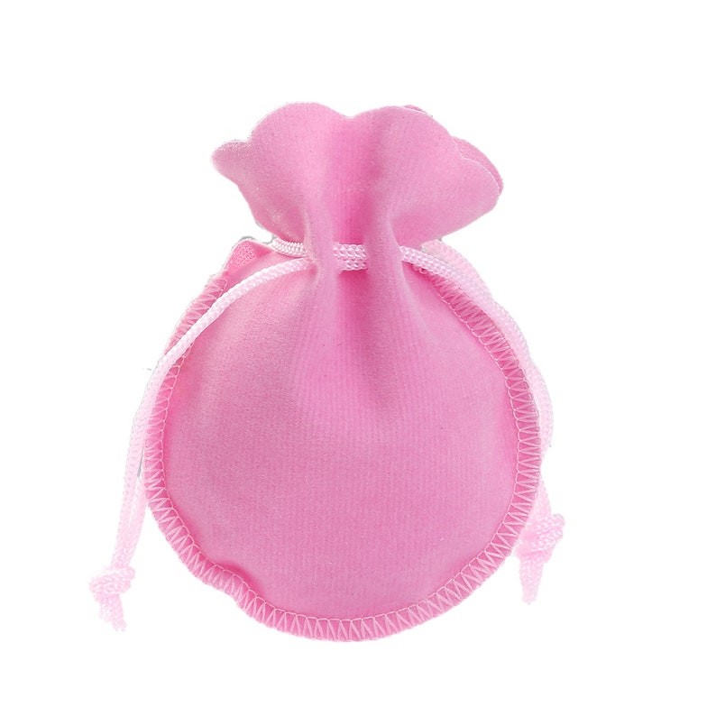 May include: A pink velvet drawstring pouch with a white cord.