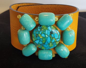 Mustard yellow leather cuff with turquoise beads.