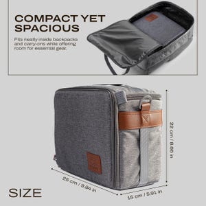 May include: Grey travel bag with brown leather detailing. The bag measures 25 cm long, 22 cm high, and 15 cm wide. The text "COMPACT YET SPACIOUS" is displayed. The bag features a top handle and a zip closure.