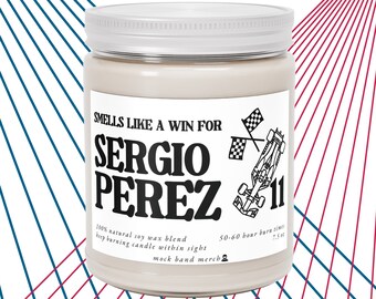 May include: A white candle jar with a black and white label that says "Smells Like A Win For Sergio Perez 11". The label also includes a black and white illustration of a race car and checkered flags. The candle is 100% natural soy wax blend and has a 50-60 hour burn time.