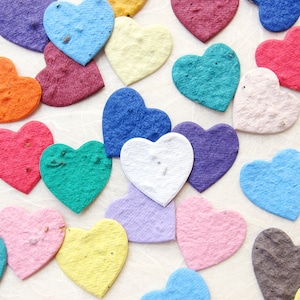 May include: Assortment of colorful paper hearts in various shades of red, pink, blue, green, yellow, orange, and purple. The hearts are made of recycled paper and are biodegradable.
