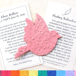May include: A pink paper dove with embedded seeds for planting. The dove is on a white card with the text "Planting Instructions" and a list of flowers that can be grown from the seeds. The card also includes instructions on how to plant the seeds.