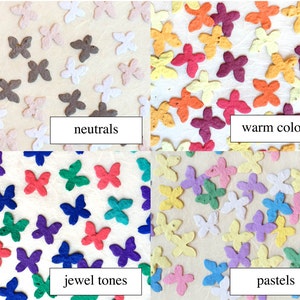 Puede incluir: Cuatro juegos de mariposas de papel de colores, cada juego representa un esquema de color diferente: neutros, colores c&aacute;lidos, tonos joya y pasteles.