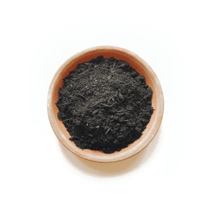 May include: A close-up of a terracotta pot filled with dark brown soil.