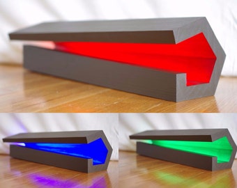 May include: Three hexagonal shaped boxes with lids open, revealing a red, blue, and green light inside each box.