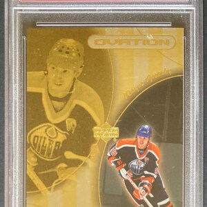 May include: A hockey trading card featuring Wayne Gretzky from the 1999 U.D. Ovation series. The card is graded by PSA and labeled "Center Stage." The card has a gold background with images of Gretzky in action.