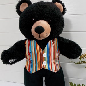 Build a bear teddy bear wearing a multi-coloured striped patterned waistcoat and black trousers