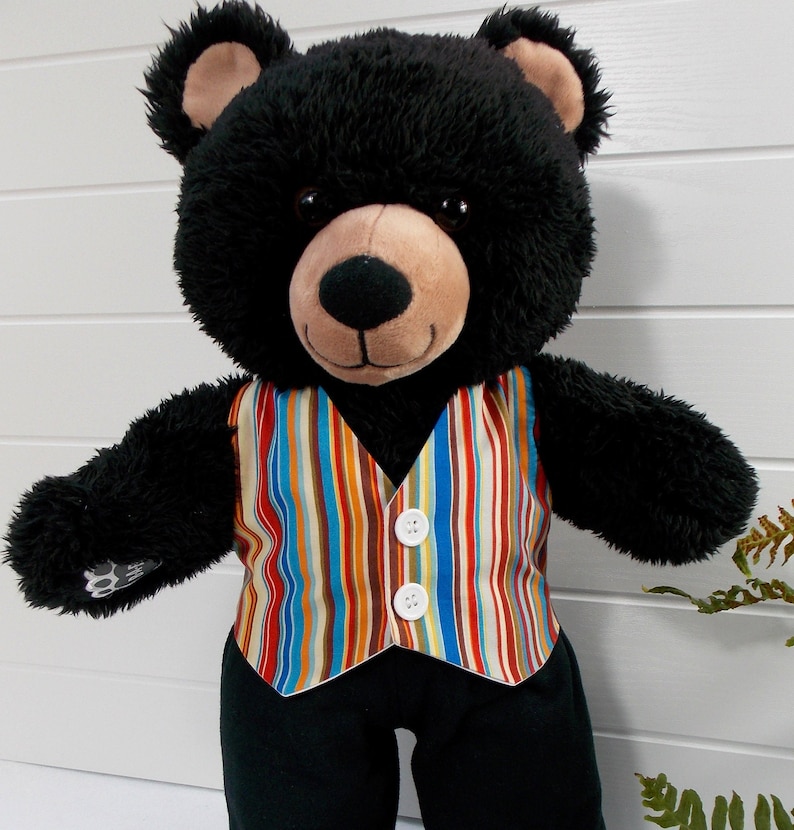 Build a bear teddy bear wearing a multi-coloured striped patterned waistcoat and black trousers