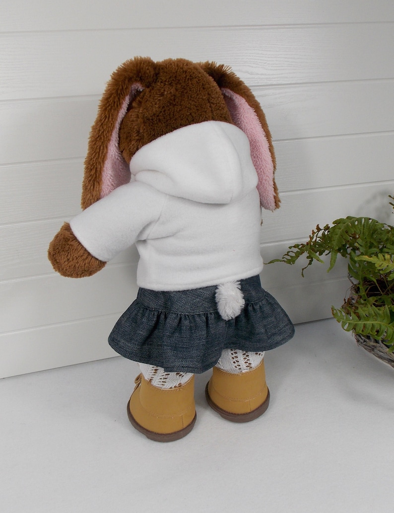 A build a bear teddy bear wearing a white hoodie, blue denim skirt and sand coloured boots