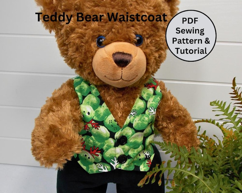 May include: A brown teddy bear wearing a green and red waistcoat with a pattern of green vegetables. The waistcoat has black buttons. The teddy bear is wearing black trousers. The image includes the text "Teddy Bear Waistcoat PDF Sewing Pattern & Tutorial".