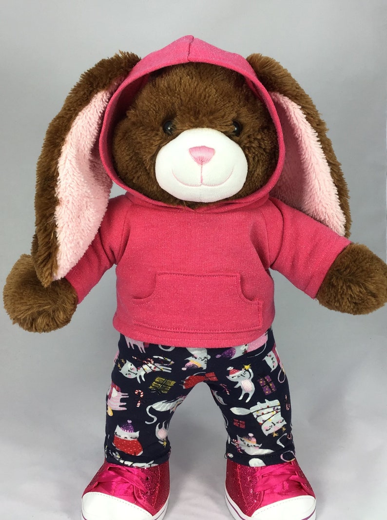 Build a bear teddy bear wearing a pink hoodie and multicoloured leggings