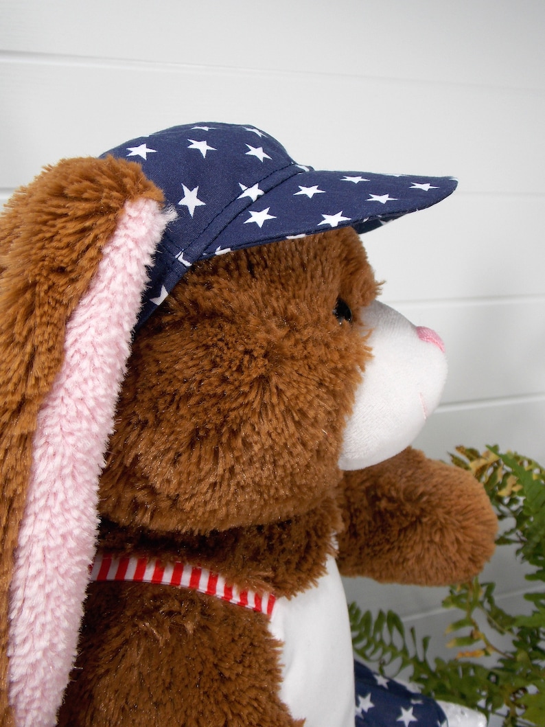 Build a bear teddy bear wearing a blue baseball cap with white stars