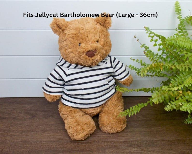 Jellycat Bartholomew Bear wearing a black and white striped hoodie