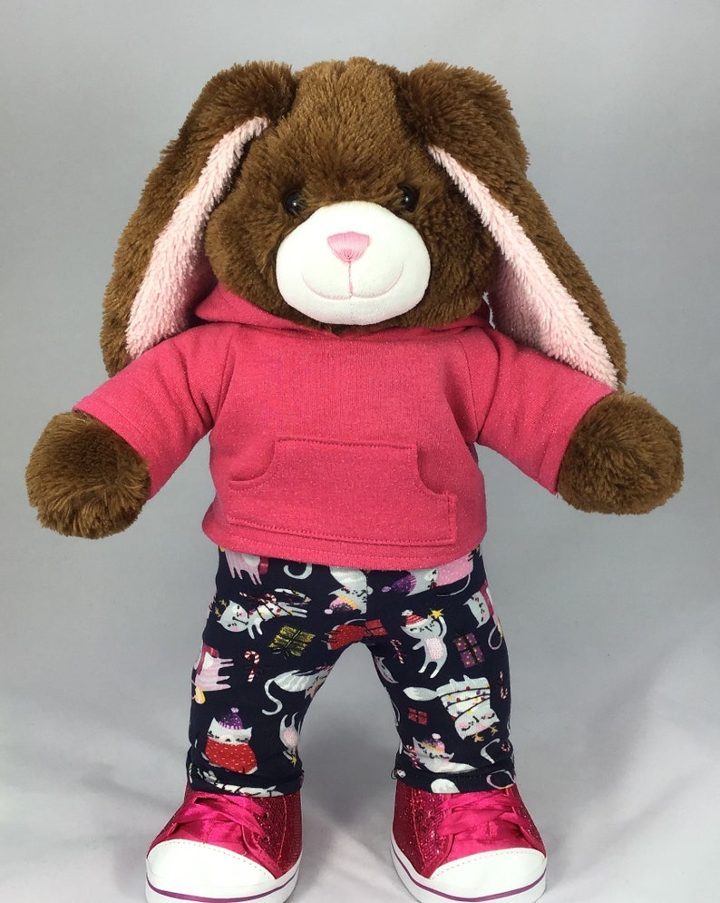 Build a bear teddy bear wearing a pink hoodie and multicoloured leggings