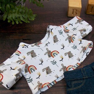 Teddy Bear T-shirt on wooden surface. The teddy bear t-shirt has been made from a sewing pattern by Best Dressed Bears