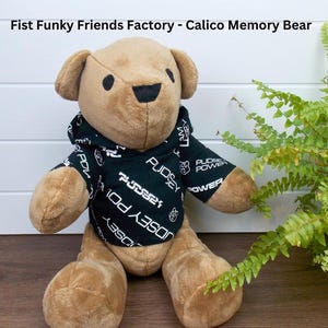 Funky Friends Factory Calico Bear wearing a black patterned hoodie