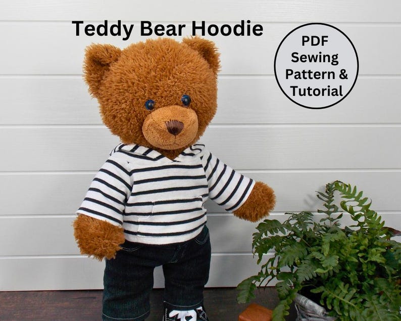 Brown Build a Bear teddy bear wearing a black and white striped hoodie, black trousers and black & white converse shoes
