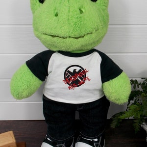 Build a bear frog wearing a black and white t-shirt, black jeans and black and white converse style trainers.