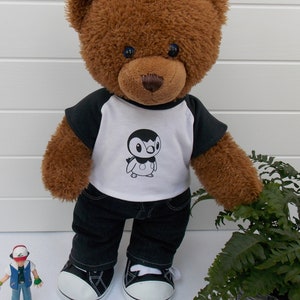 Build a bear teddy bear wearing a black and white t-shirt, black jeans and black and white converse style trainers.