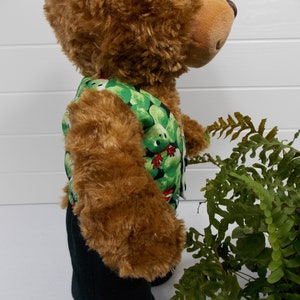 Build a bear teddy bear wearing a green patterned waistcoat, black trousers and black shoes