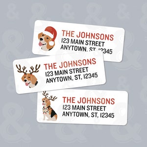 May include: Three white rectangular return address labels with a cartoon beagle dog wearing a Santa hat, reindeer antlers, and Christmas lights. The labels have the text "THE JOHNSONS 123 MAIN STREET ANYTOWN, ST, 12345" printed on them.