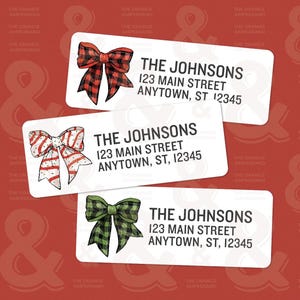 May include: Three white return address labels with a festive Christmas bow design. Each label features the text "THE JOHNSONS", "123 MAIN STREET", and "ANYTOWN, ST, 12345". The bows are red and black plaid, red and white striped, and green and black plaid.