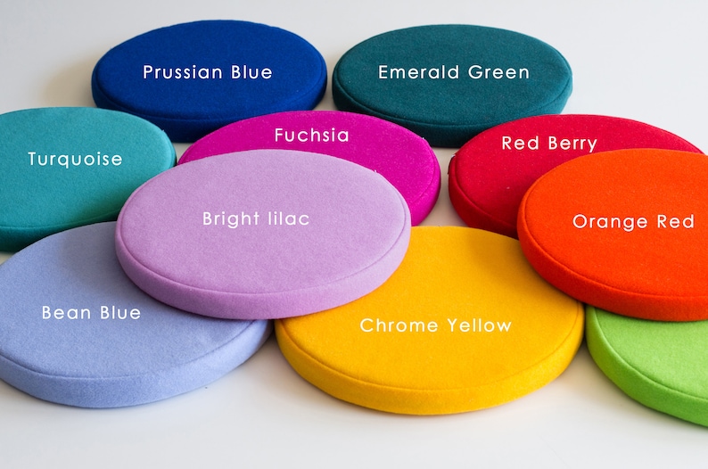 May include: Nine round felt cushions in various colors, including turquoise, bean blue, Prussian blue, fuchsia, bright lilac, emerald green, red berry, chrome yellow, and orange red.