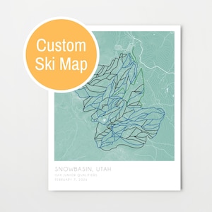 May include: A custom ski map print featuring a detailed topographical design in shades of blue and black over a light green background. The print includes the text "Custom Ski Map" in a yellow circle, and the location "Snowbasin, Utah".