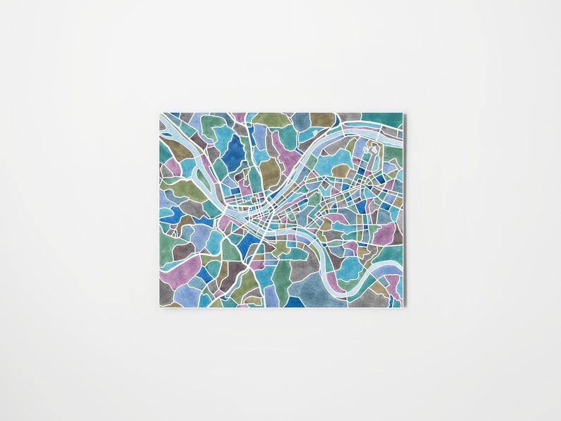 May include: A watercolor illustration of a city map with a river winding through it. The map is in shades of blue, green, purple, and gray.