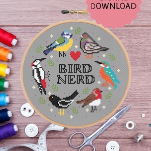 May include: A cross-stitch embroidery hoop featuring a design with various birds, a red heart, and the text "BIRD NERD" in black. The hoop is surrounded by sewing supplies, including colorful thread spools, buttons, and scissors. A pink starburst graphic reads "DIGITAL DOWNLOAD".
