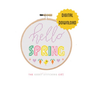 May include: A cross-stitch embroidery hoop featuring the words "hello SPRING" in pastel shades. The design includes hearts, carrots, and a yellow chick. A yellow starburst graphic reads "DIGITAL DOWNLOAD".