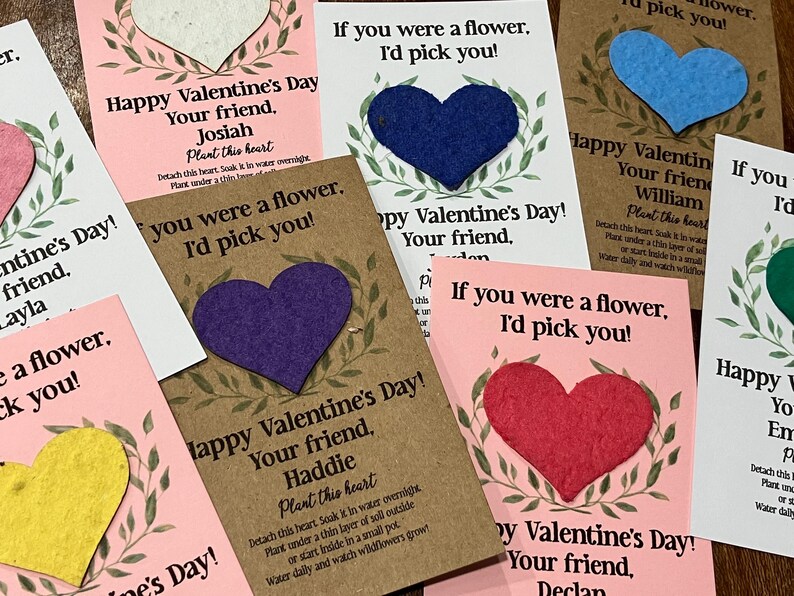 May include: Valentine's Day cards with heart-shaped seed paper. Each card has a heart in a different color, with text that reads "If you were a flower, I'd pick you!" and "Happy Valentine's Day!"