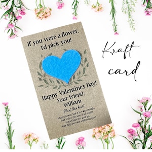May include: A kraft paper Valentine's Day card with a blue heart and the text "If you were a flower, I'd pick you!" and "Happy Valentine's Day! Your friend, William". The card includes instructions to plant the heart. The word "Kraft card" is written in cursive.