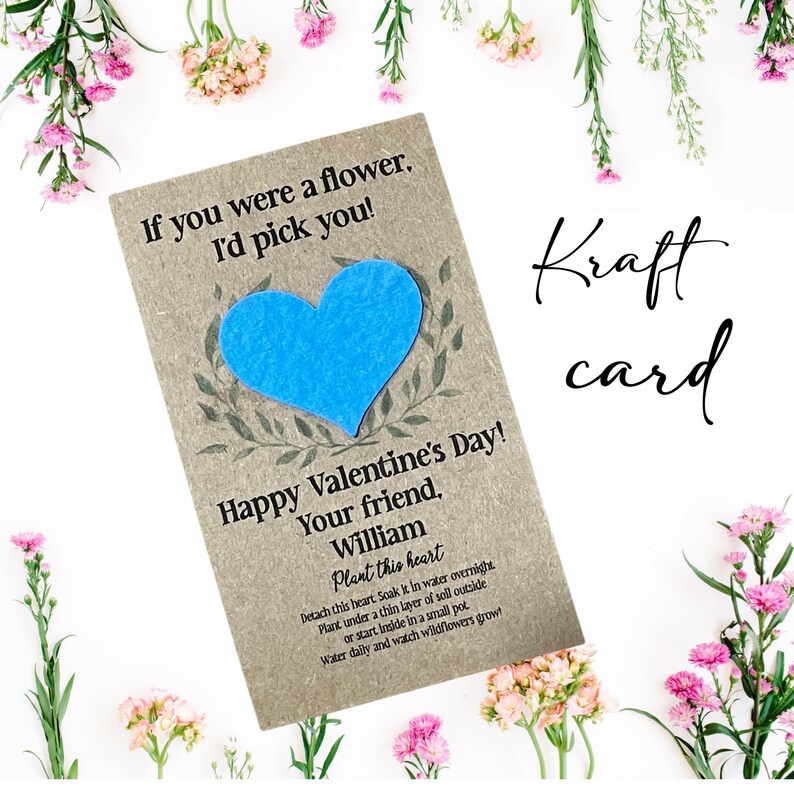 May include: A kraft paper Valentine's Day card with a blue heart and the text "If you were a flower, I'd pick you!" and "Happy Valentine's Day! Your friend, William". The card includes instructions to plant the heart. The word "Kraft card" is written in cursive.