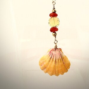 Necklace, 18in of 14k gold-fill chain supporting gold-filled wire-wrapped Sunrise shell from Hawaii; faceted 10mm Carnelian & 2 rondelles.