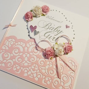 Soft Pink and White Flowers Baby Girl Card with a detailed Metallic pink background