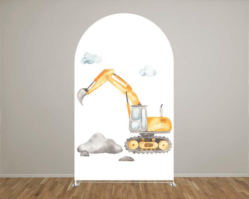 May include: A white arch-shaped backdrop featuring a watercolor illustration of a yellow excavator with a raised arm, gray rocks, and two fluffy blue clouds. The excavator has a gray bucket and black tracks. The backdrop is set against a light gray wall and a wooden floor.