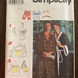 May include: Simplicity sewing pattern number 9365 for a robe with a pocket. The pattern includes instructions for making a robe with a drawstring and a pocket. The pattern is for one size.