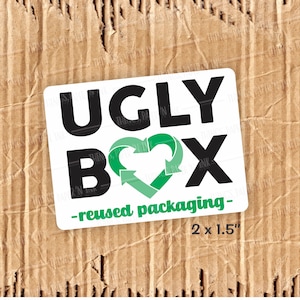 May include: White sticker with black text that reads "UGLY BOX - reused packaging -" with a green heart symbol containing two arrows in a circle. The sticker also includes the text "2 x 1.5"
