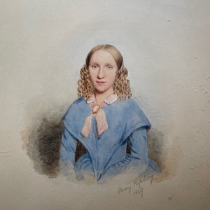 May include: A watercolor portrait of a young woman with long, curly blonde hair. She is wearing a blue dress with a pink ribbon and a cameo brooch. The portrait is signed "Mary Kipling 1847".