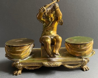 Antique Brass Desk Stand with a playful seated Cherub about to bang his Drums