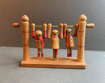 Three Synchronised Giggling Articulated Wooden Gymnasts on the Bar