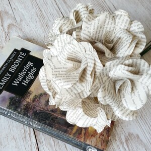 May include: A bouquet of paper flowers made from the pages of a book. The book is a classic edition of "Wuthering Heights" by Emily Bront&euml;.