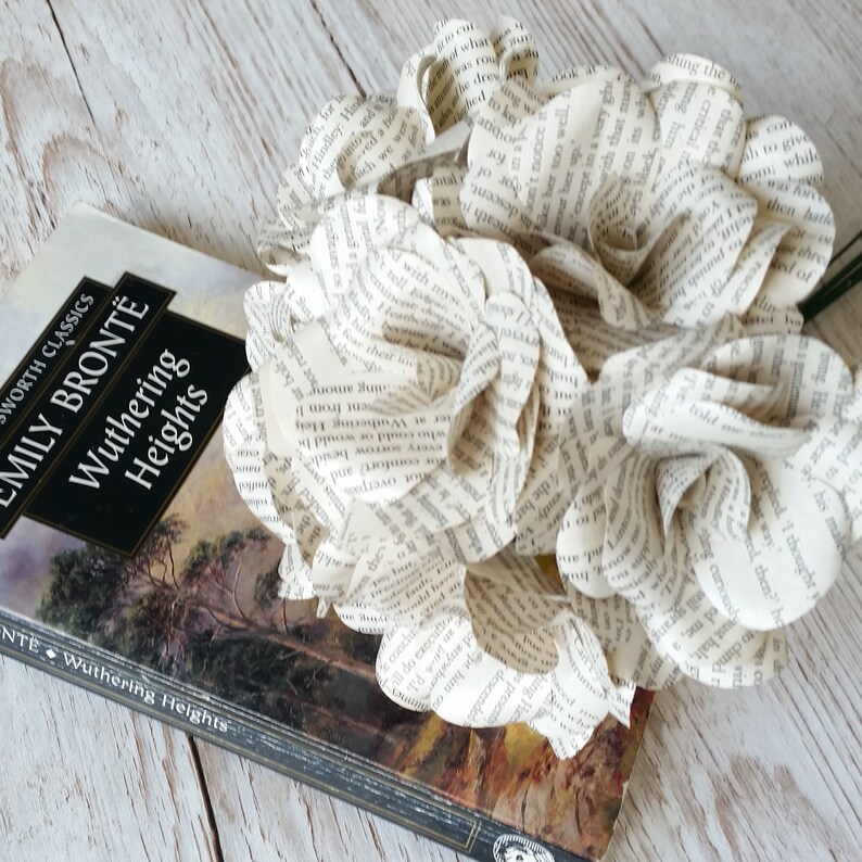 May include: A bouquet of paper flowers made from the pages of a book. The book is a classic edition of "Wuthering Heights" by Emily Bront&euml;.