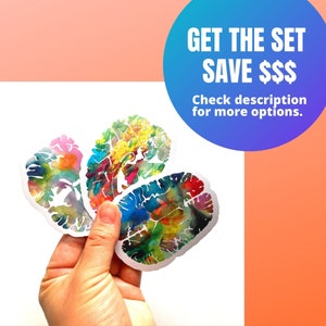 May include: Three colourful watercolour brain stickers. The stickers are in the shape of a human brain and feature a variety of colours, including blue, green, yellow, orange, pink, and red. The text "GET THE SET SAVE $$$ Check description for more options." is visible in the image.